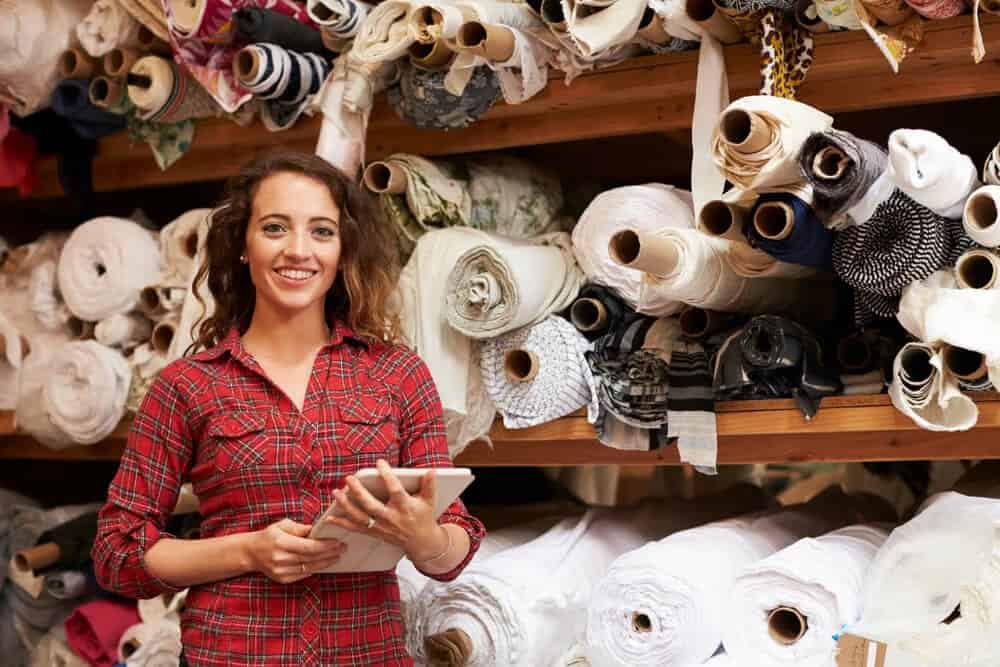 lady stood in front of fabric stock for business self storage