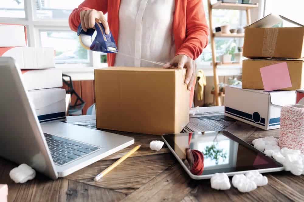 lady taping box on desk for self storage